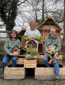 Carrie Cort & Lily's Cottage with a pollination education station Carrie Cort with representatives from Lily's Cottage, with a pollination education station