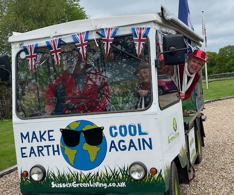 IMG_3295 (1) an environmental eco milk float with the words Make Earth Cool Again painted on the front.